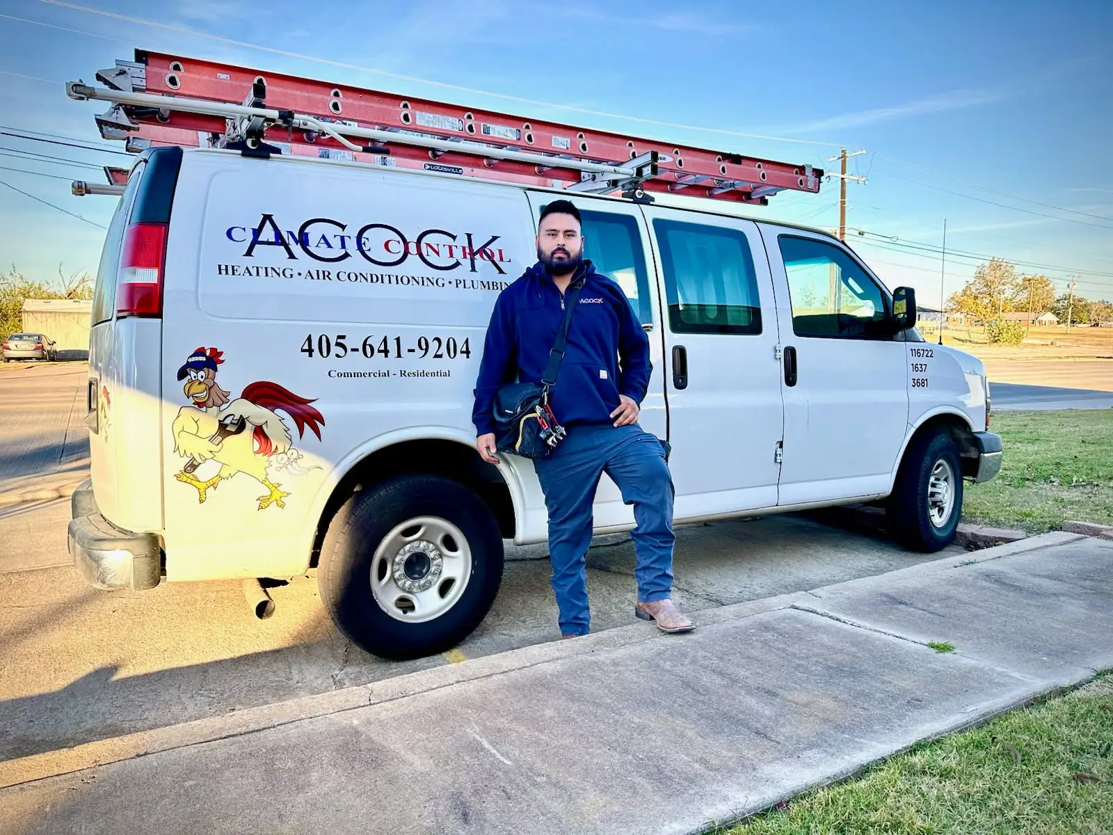Acock Climate Control technician standing beside branded service van
